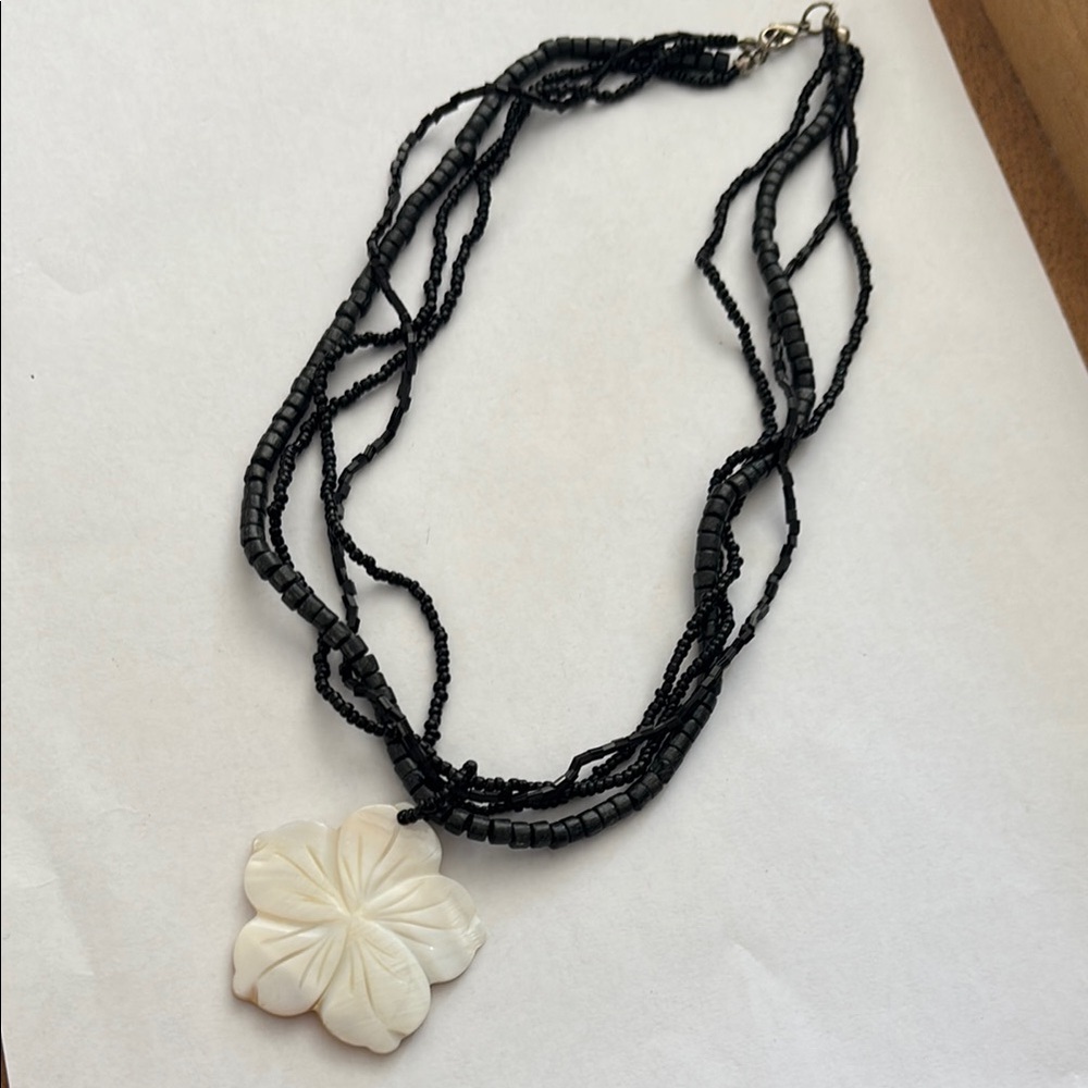 Elegant Black Beaded Necklace with White Floral Pendant